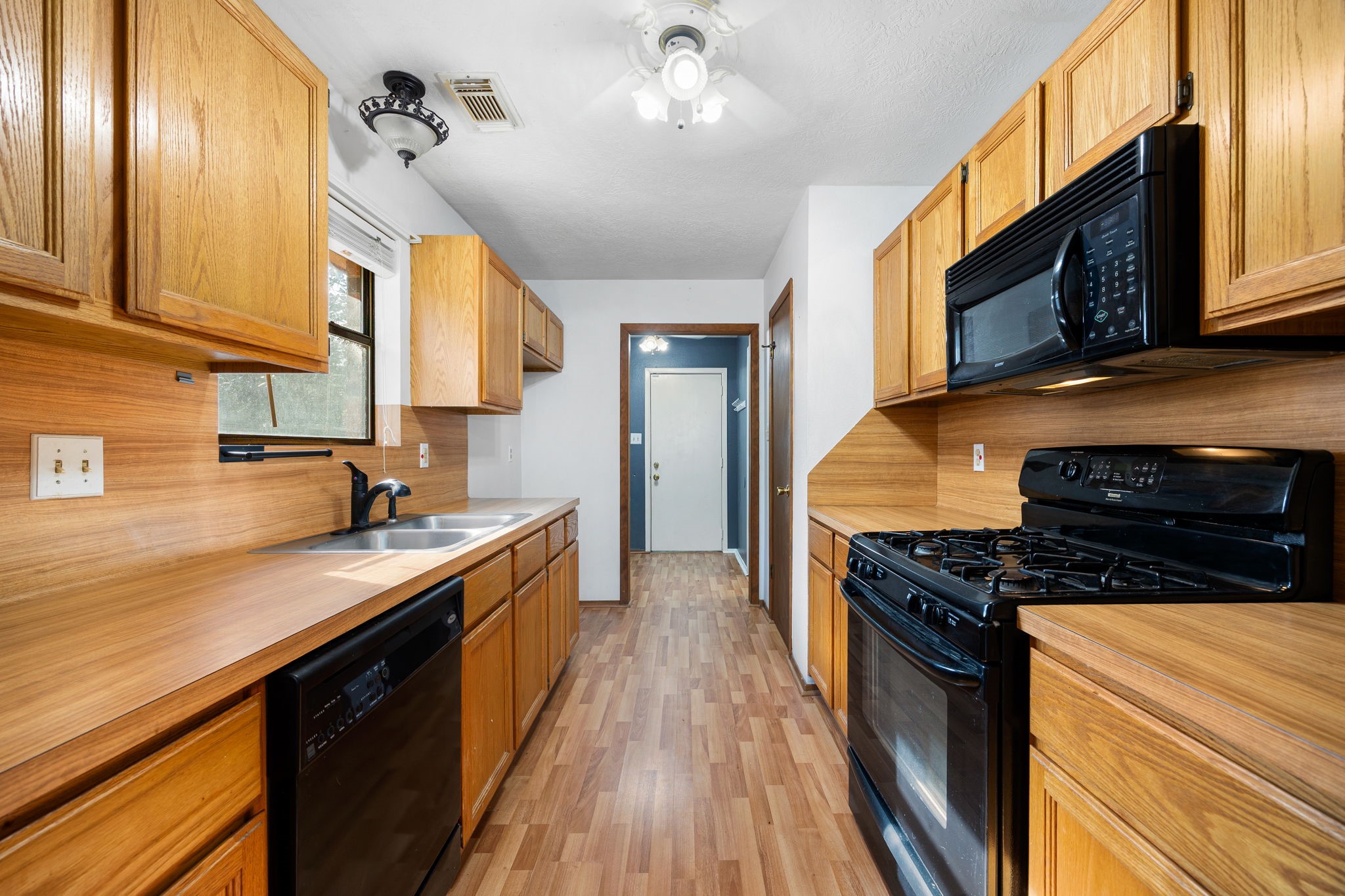 236 Pine Ridge Drive Cleveland, TX 77327 - Photo 8 of 30 a kitchen with stainless steel appliances a stove sink and cabinets