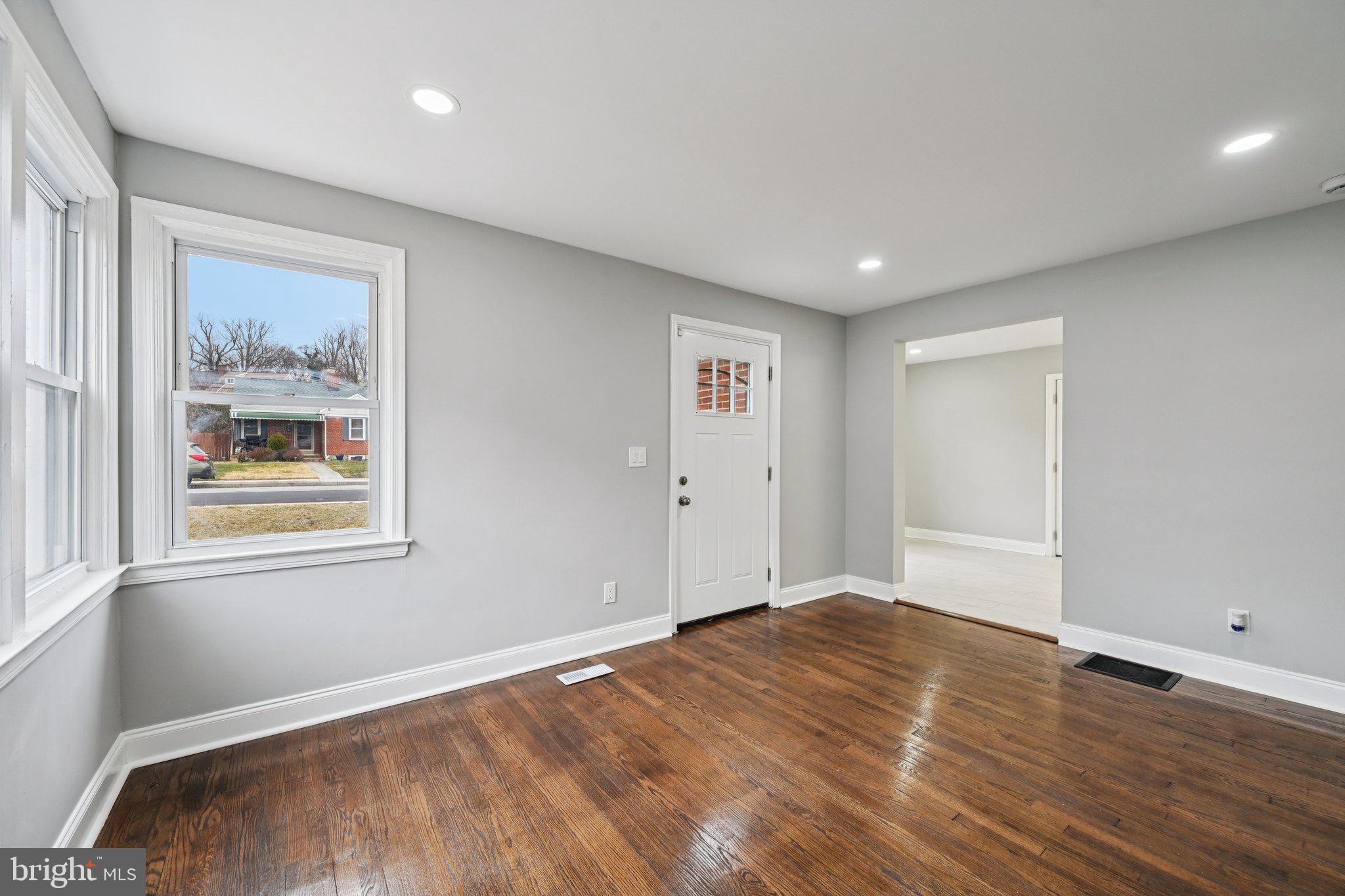 4902 Gilray Drive Baltimore, MD 21214 - Photo 11 of 54 a view of empty room with wooden floor and window