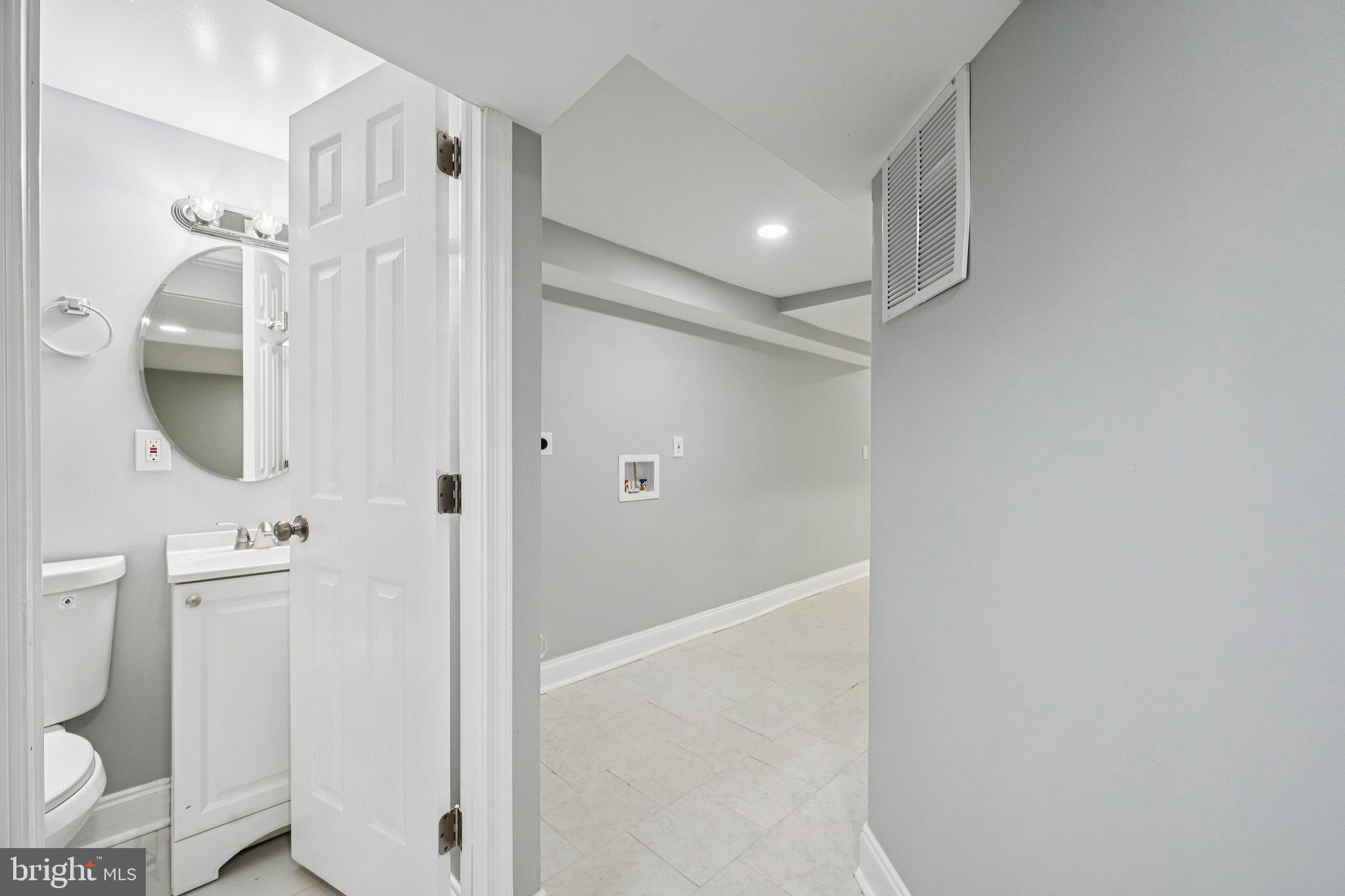 4902 Gilray Drive Baltimore, MD 21214 - Photo 39 of 54 a bathroom with a shower a toilet and a sink