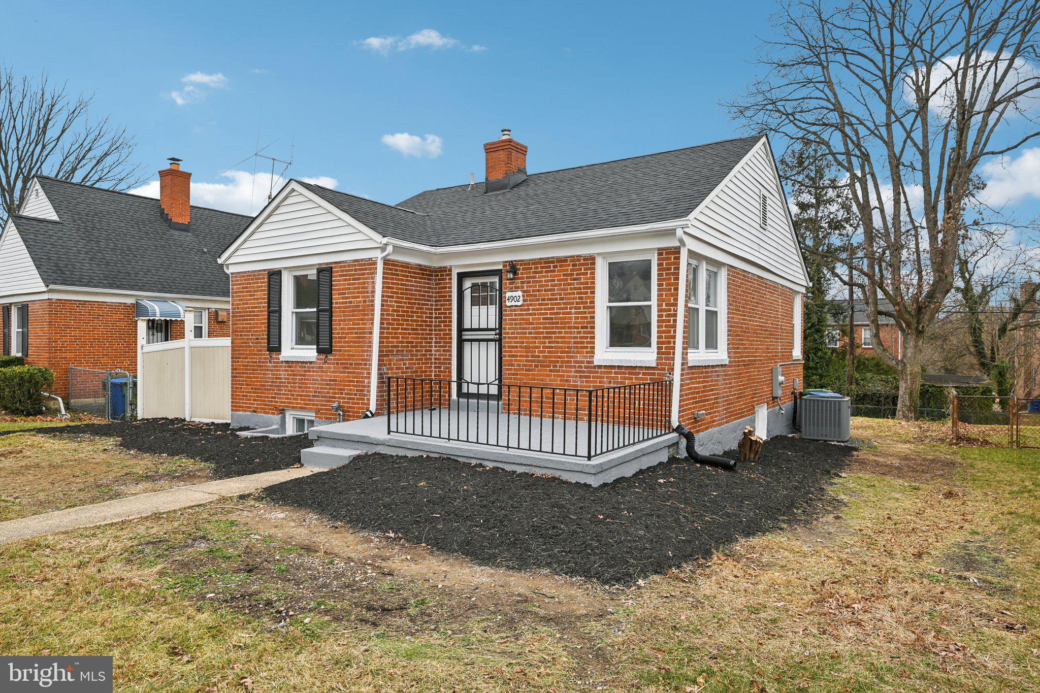 4902 Gilray Drive Baltimore, MD 21214 - Photo 4 of 54 a front view of a house with a yard