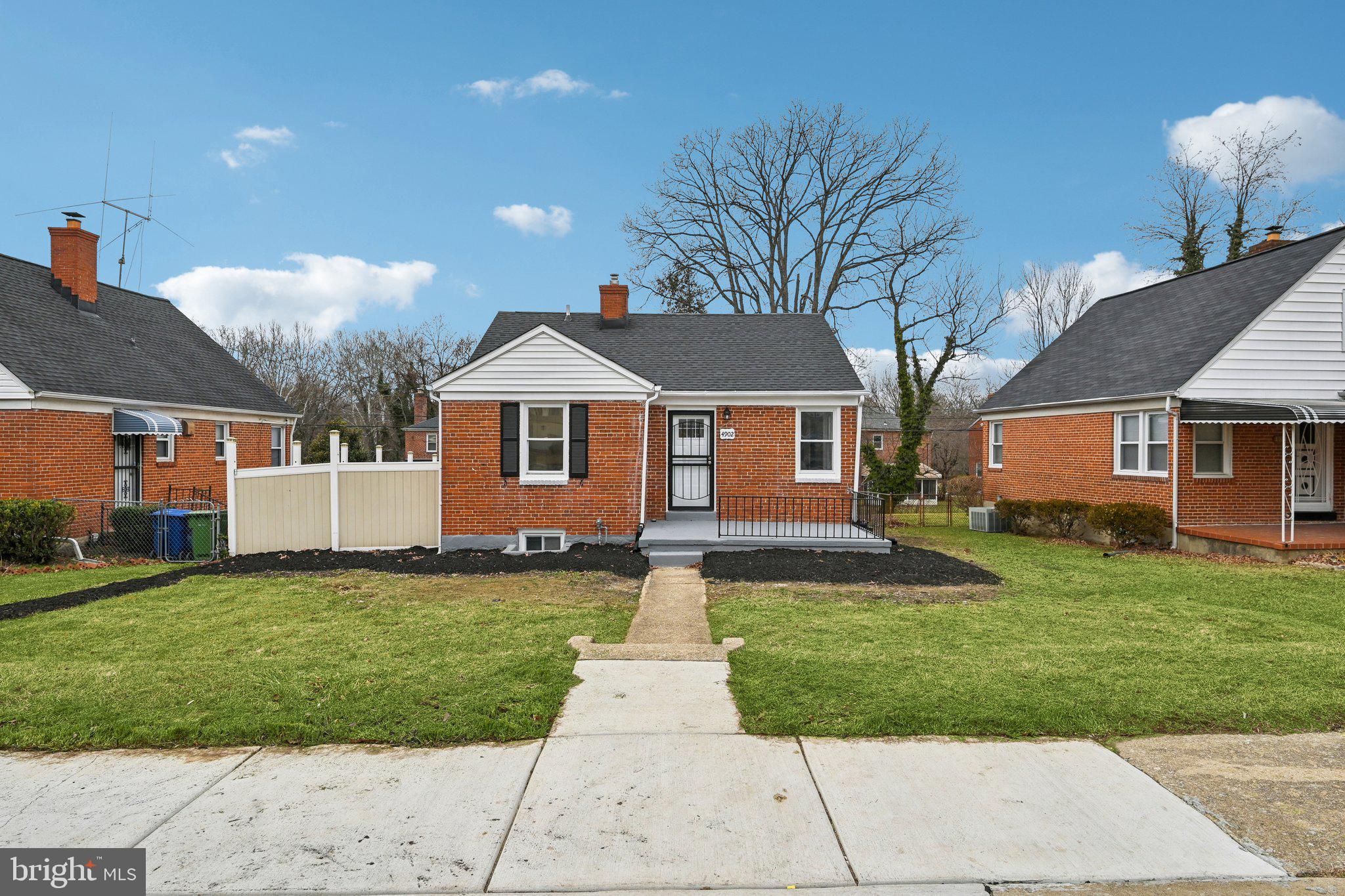 4902 Gilray Drive Baltimore, MD 21214 - Photo 6 of 54 a front view of a house with a yard