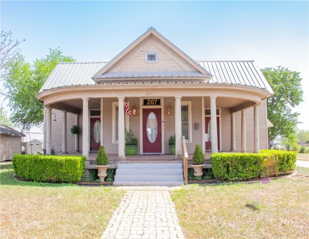 a front view of a house with garden