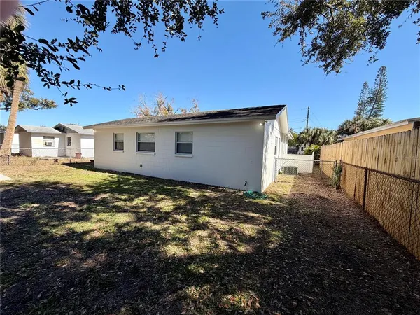 a view of a yard with wooden fence