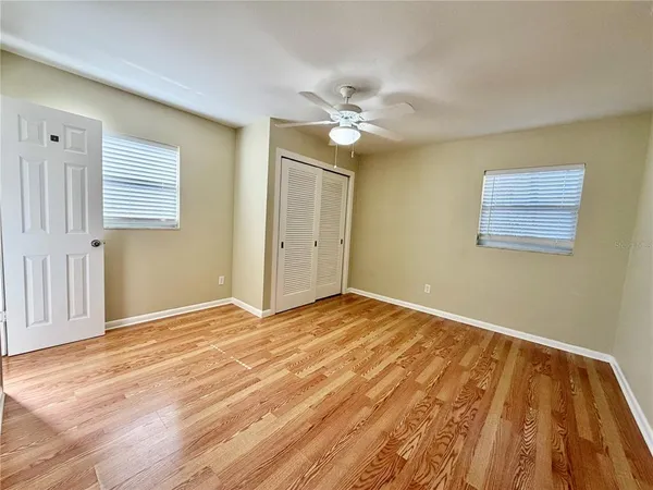 a view of an empty room with wooden floor