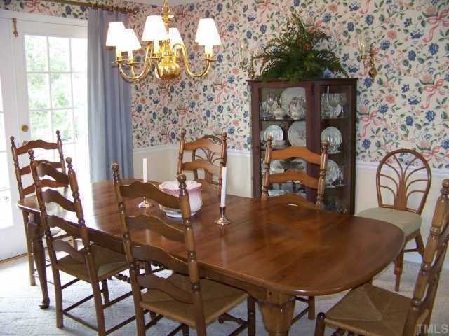4210 Laurel Ridge Drive Raleigh, NC 27612 - Photo 6 of 12 Formal DR is expandable into LR for those extra large parties. Room for furniture placement on both sides with lots of wall space. Original sliding doors have been replaced with "French Doors" opening to brick patio.