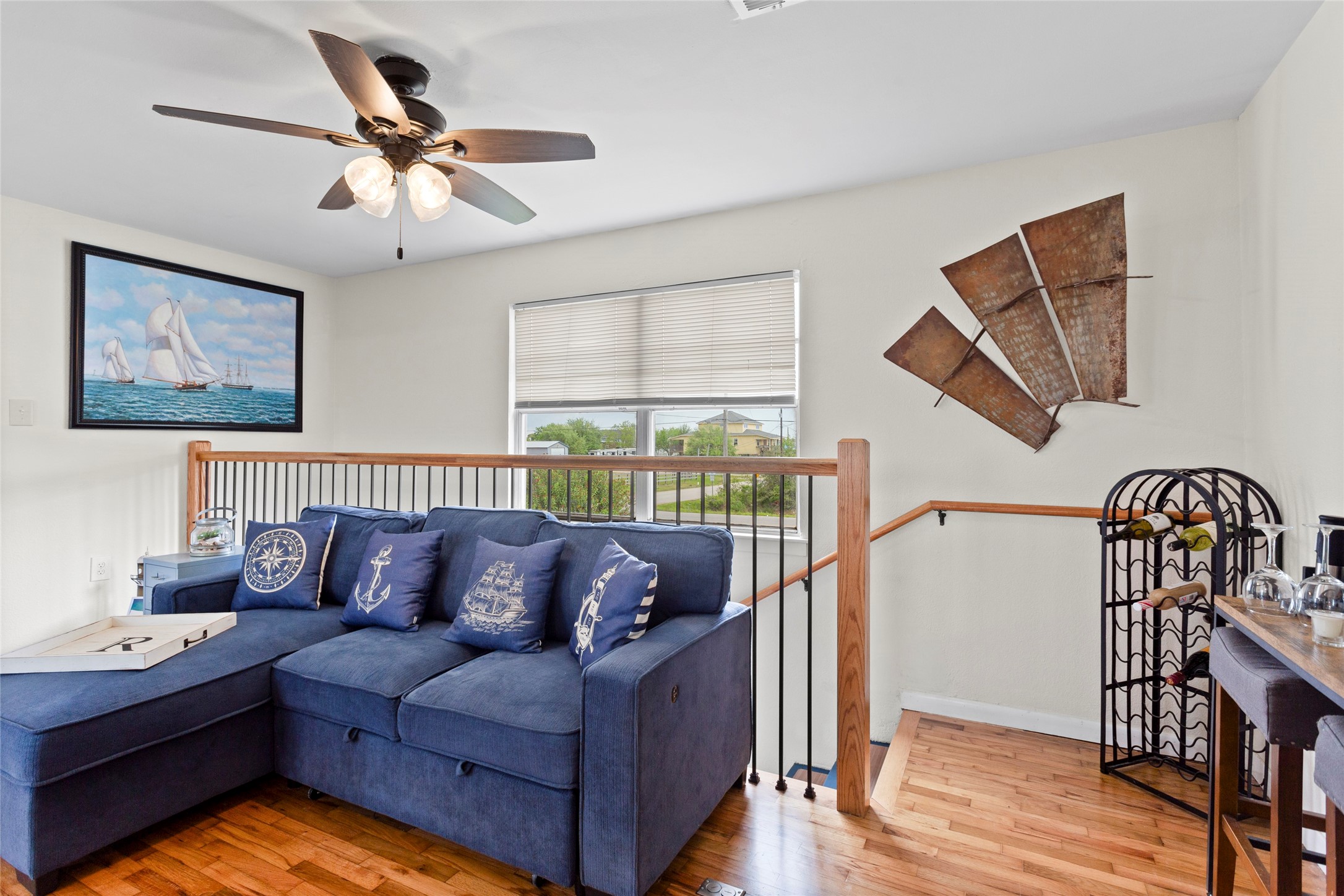 1619 FM 517 Road East San Leon, TX 77539 - Photo 11 of 27 This the second floor living room space that includes a ceiling fan, refinished original hardwood floors, and a window with natural light.