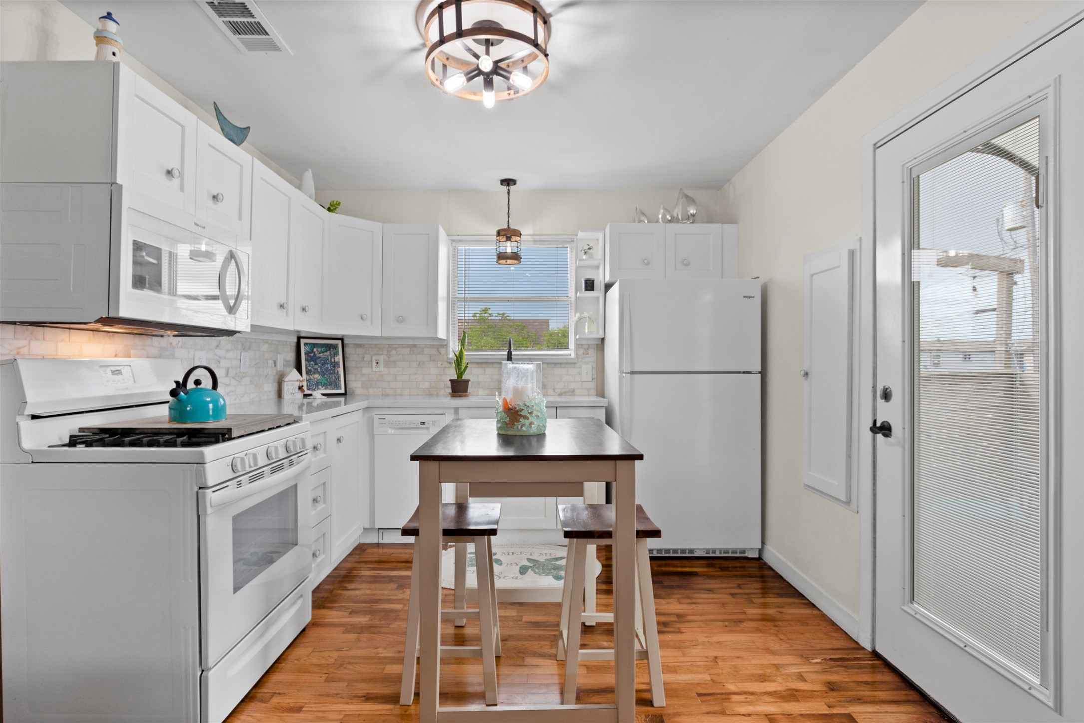 1619 FM 517 Road East San Leon, TX 77539 - Photo 14 of 27 This kitchen features white cabinetry, soft close cabinets, modern appliances, refrigerator, spice cabinet and plenty of storage.
