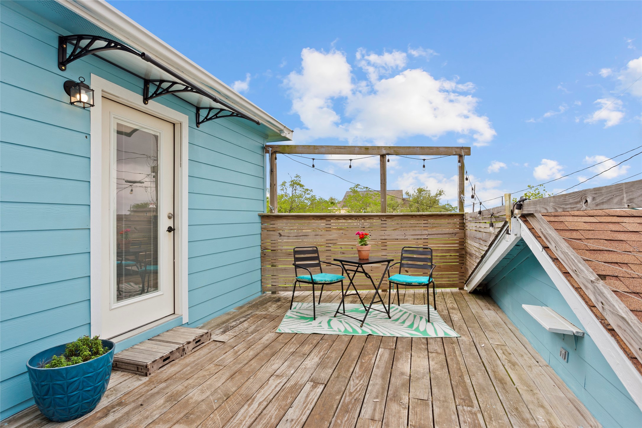 1619 FM 517 Road East San Leon, TX 77539 - Photo 19 of 27 Charming deck with a cozy seating area, perfect for relaxing or entertaining. Deck features a privacy screen and a door leading inside just off the kitchen. Water view included!