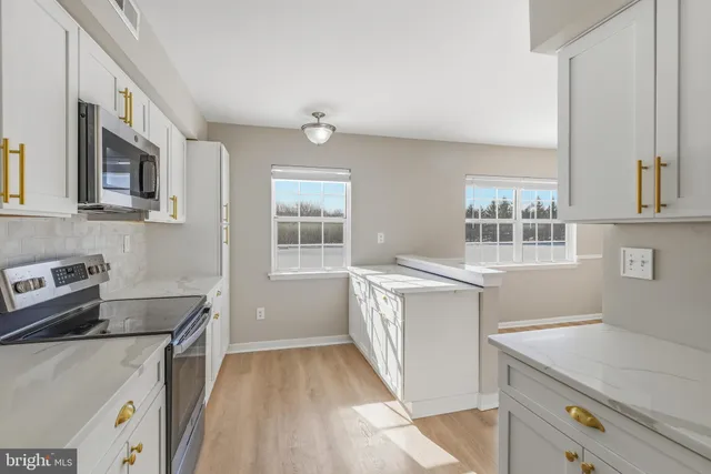 a kitchen with a sink stove and cabinets