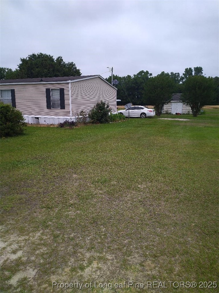 887 Stephens Road Lumberton, NC 28358 - Photo 3 of 9 a view of a lake with outdoor space