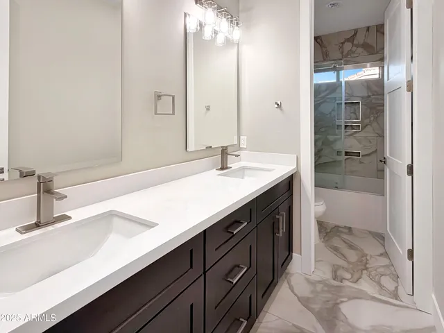 a bathroom with a sink double vanity and a mirror