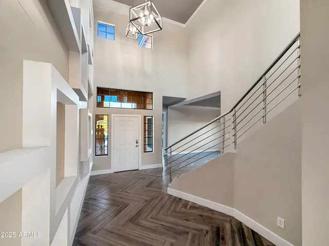 a view of a hallway with wooden floor and staircase