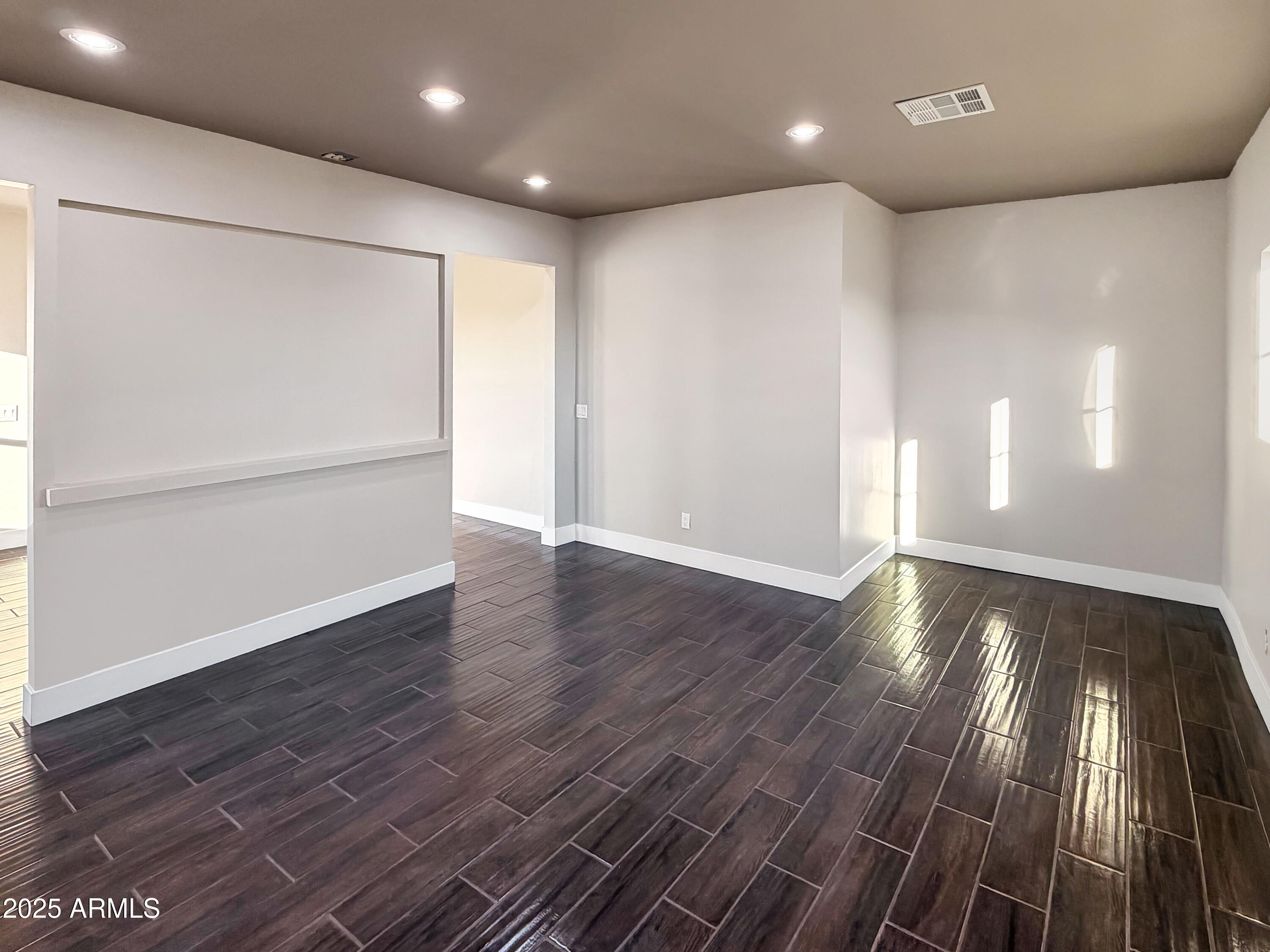 1712 East Joelle Drive Casa Grande, AZ 85122 - Photo 33 of 55 a view of an empty room with wooden floor