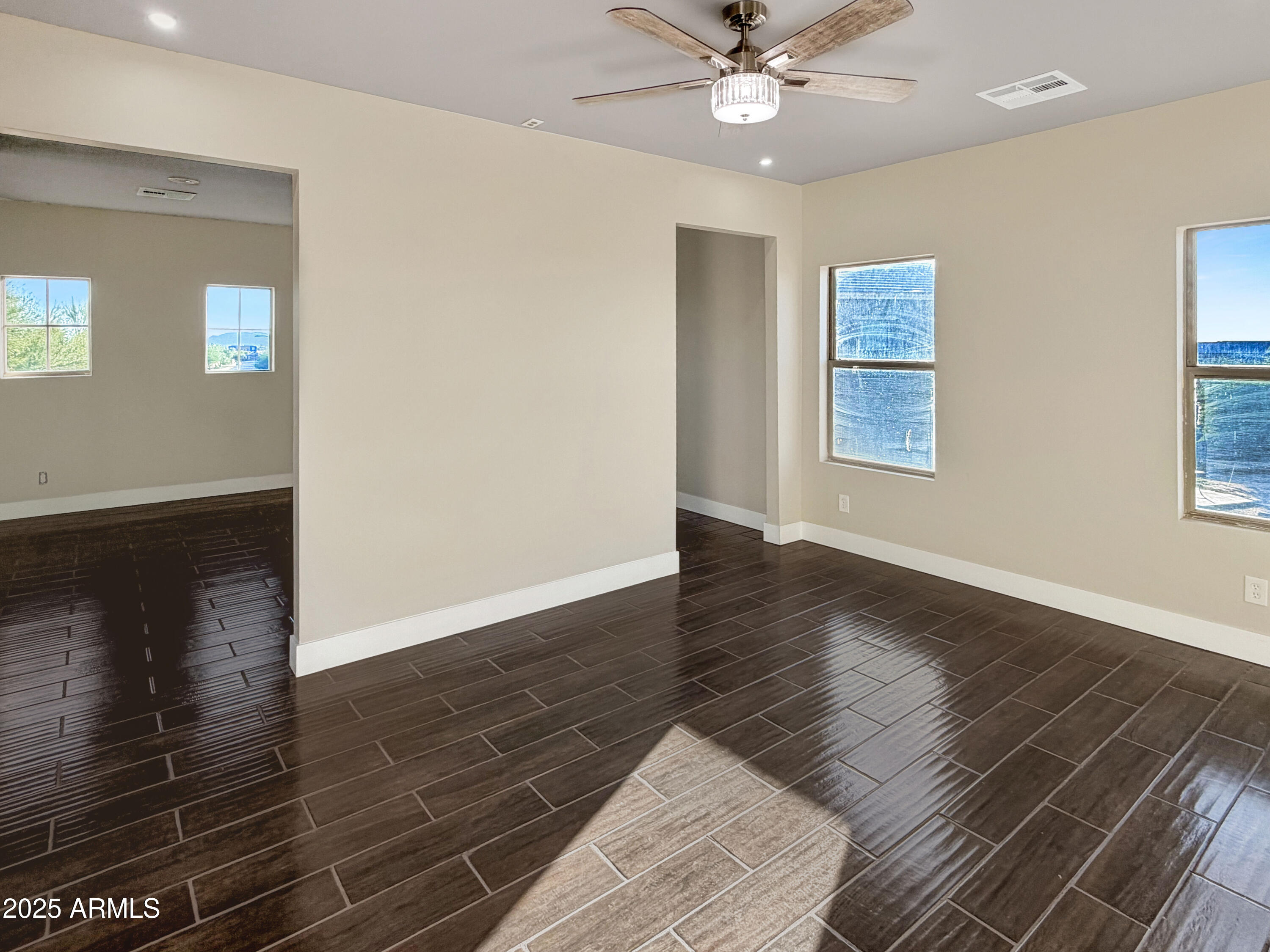 1712 East Joelle Drive Casa Grande, AZ 85122 - Photo 34 of 55 a view of an empty room with wooden floor and a window