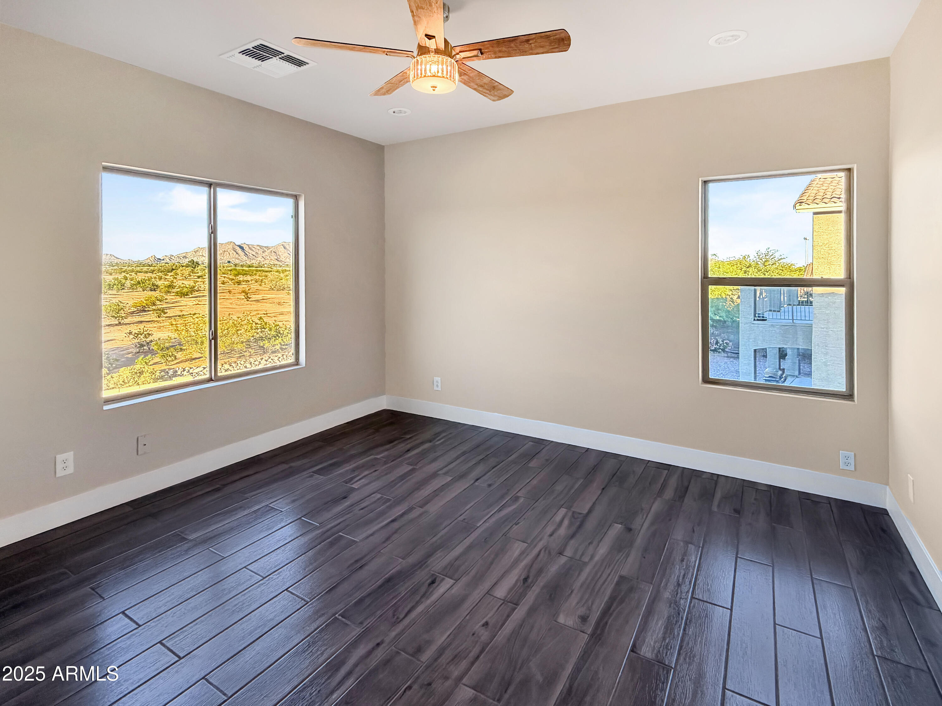 1712 East Joelle Drive Casa Grande, AZ 85122 - Photo 35 of 55 a view of an empty room with wooden floor and a window