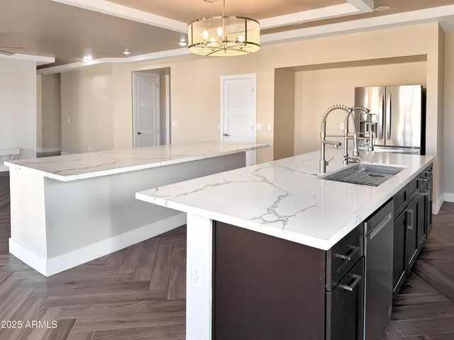 a kitchen with a sink and a wooden floor