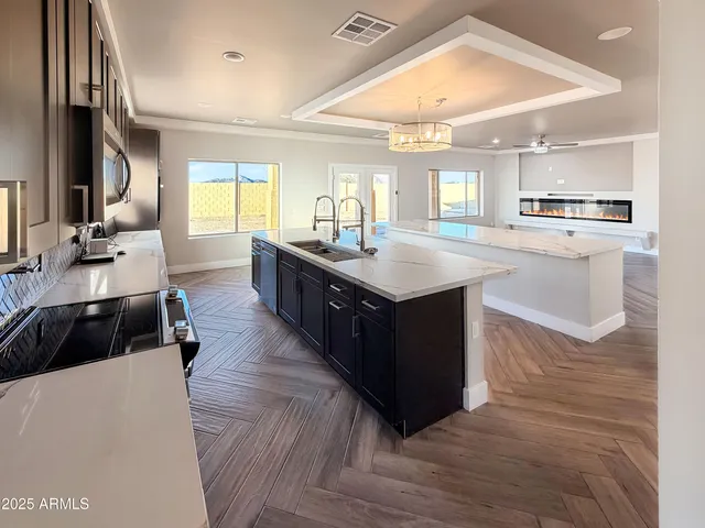 a kitchen with counter top space sink and center island