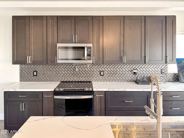 a kitchen with a sink and a stove top oven