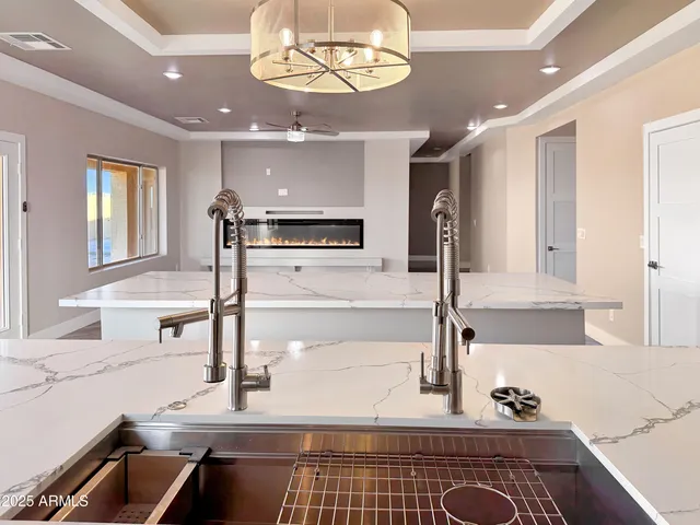 a kitchen with a sink appliances and cabinets