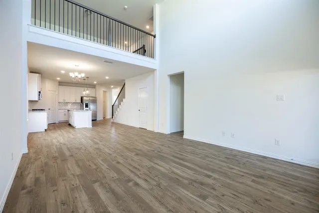 an empty room with windows and bathroom view