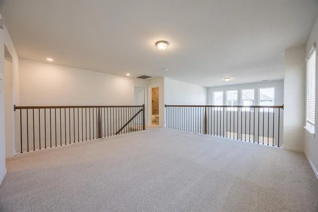 a view of an empty room and a window