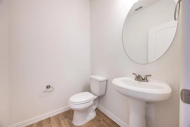 a view of a workspace with furniture and wooden floor