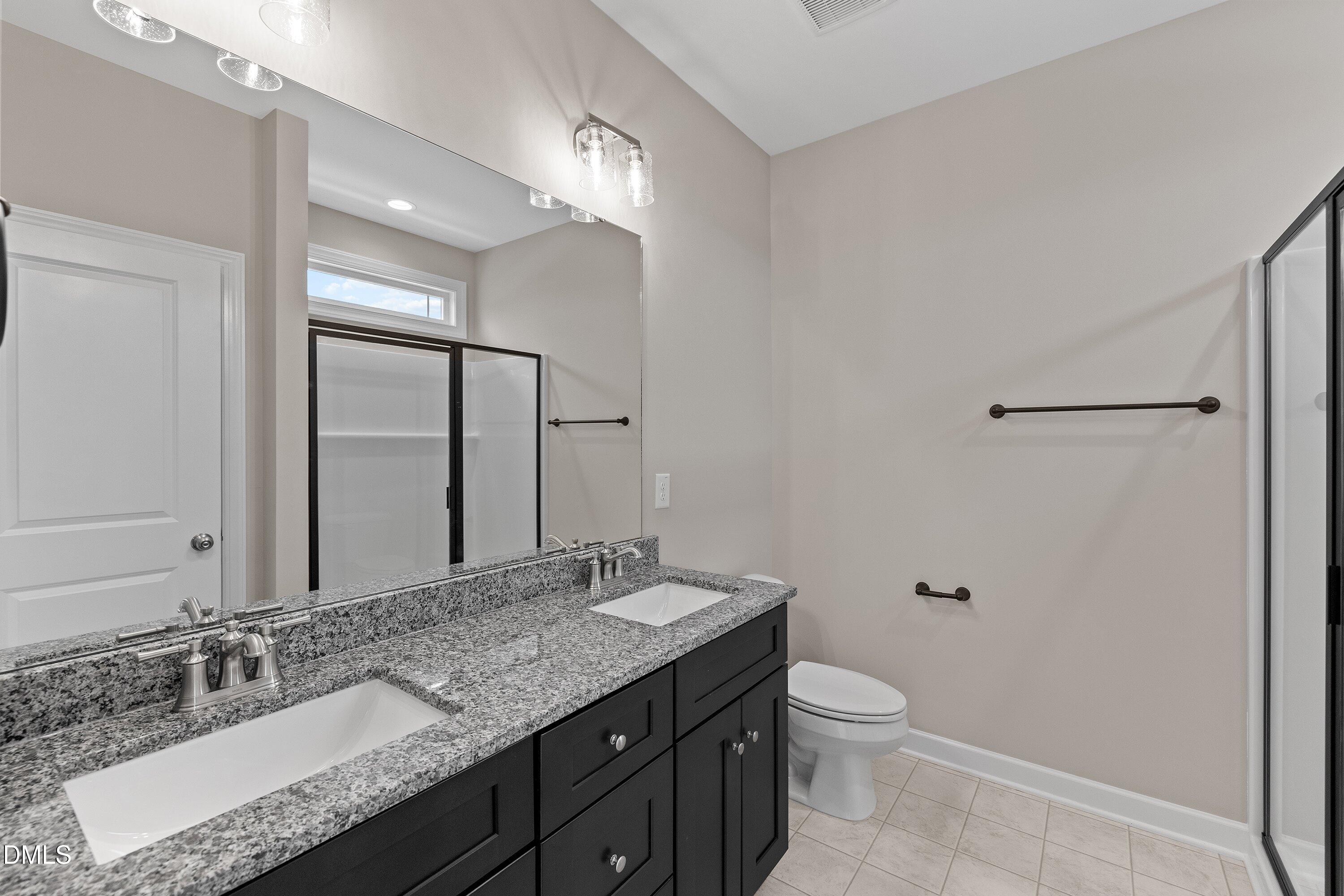 926 Micro Road West Selma, NC 27576 - Photo 35 of 41 a bathroom with a granite countertop sink toilet and mirror