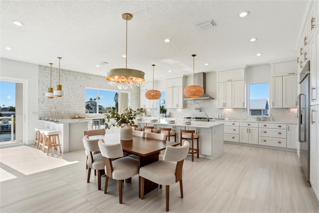 534 Crystal Drive Madeira Beach, FL 33708 - Photo 13 of 68 a large kitchen with lots of counter space dining table and chairs