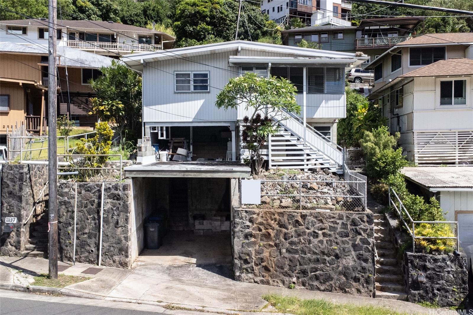 a front view of a house with plants