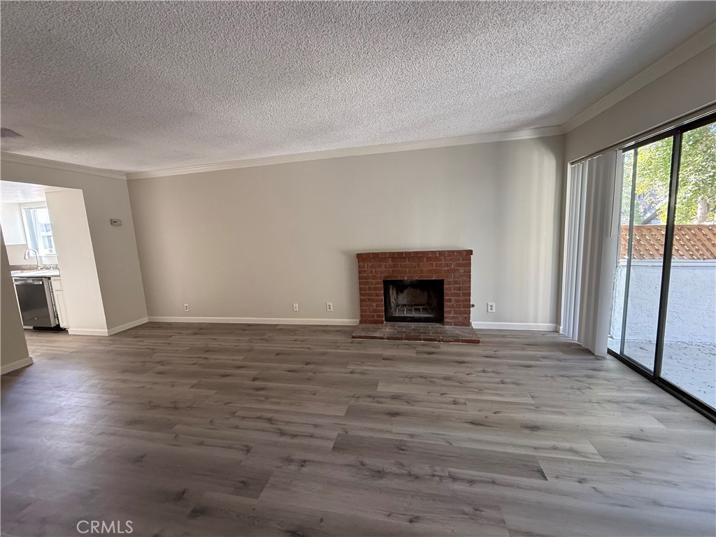 5250 Colodny Drive, Unit 17 Agoura Hills, CA 91301 - Photo 4 of 17 a view of empty room with wooden floor and fireplace