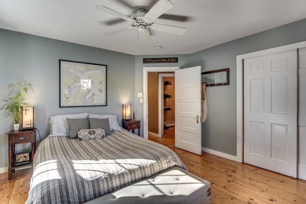 3 1/2 Becket Avenue, Unit 3 Salem, MA 01970 - Photo 13 of 22 a bedroom with a large bed and a chandelier