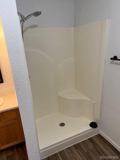 304 Sunset Lane Dacono, CO 80514 - Photo 17 of 22 a bathroom with a glass shower door