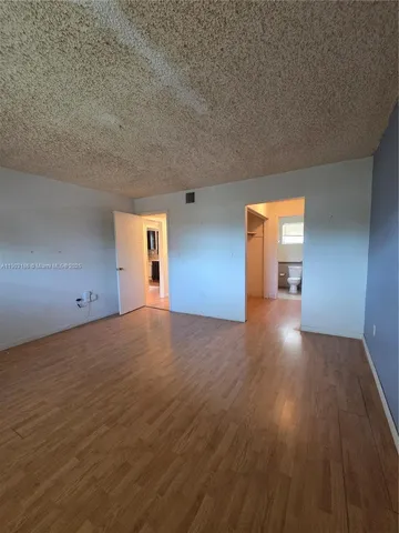 a bathroom with a granite countertop toilet sink and mirror