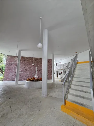 a view of open space with a big yard and large trees