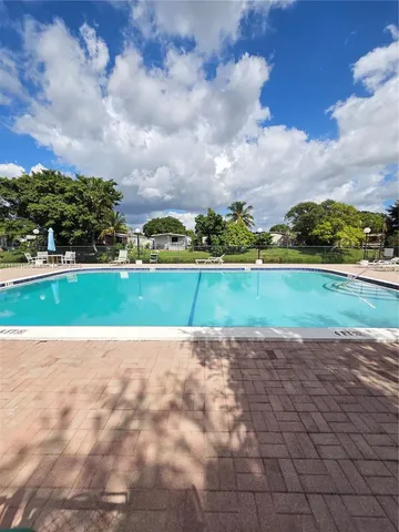 a view of a patio with table and chairs potted plants with wooden floor
