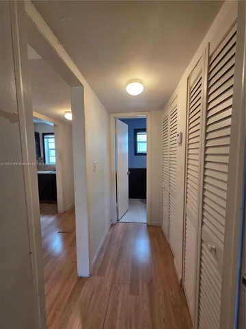 a kitchen with a sink cabinets and wooden floor
