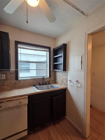 a kitchen with stainless steel appliances granite countertop wooden cabinets a refrigerator and dishwasher