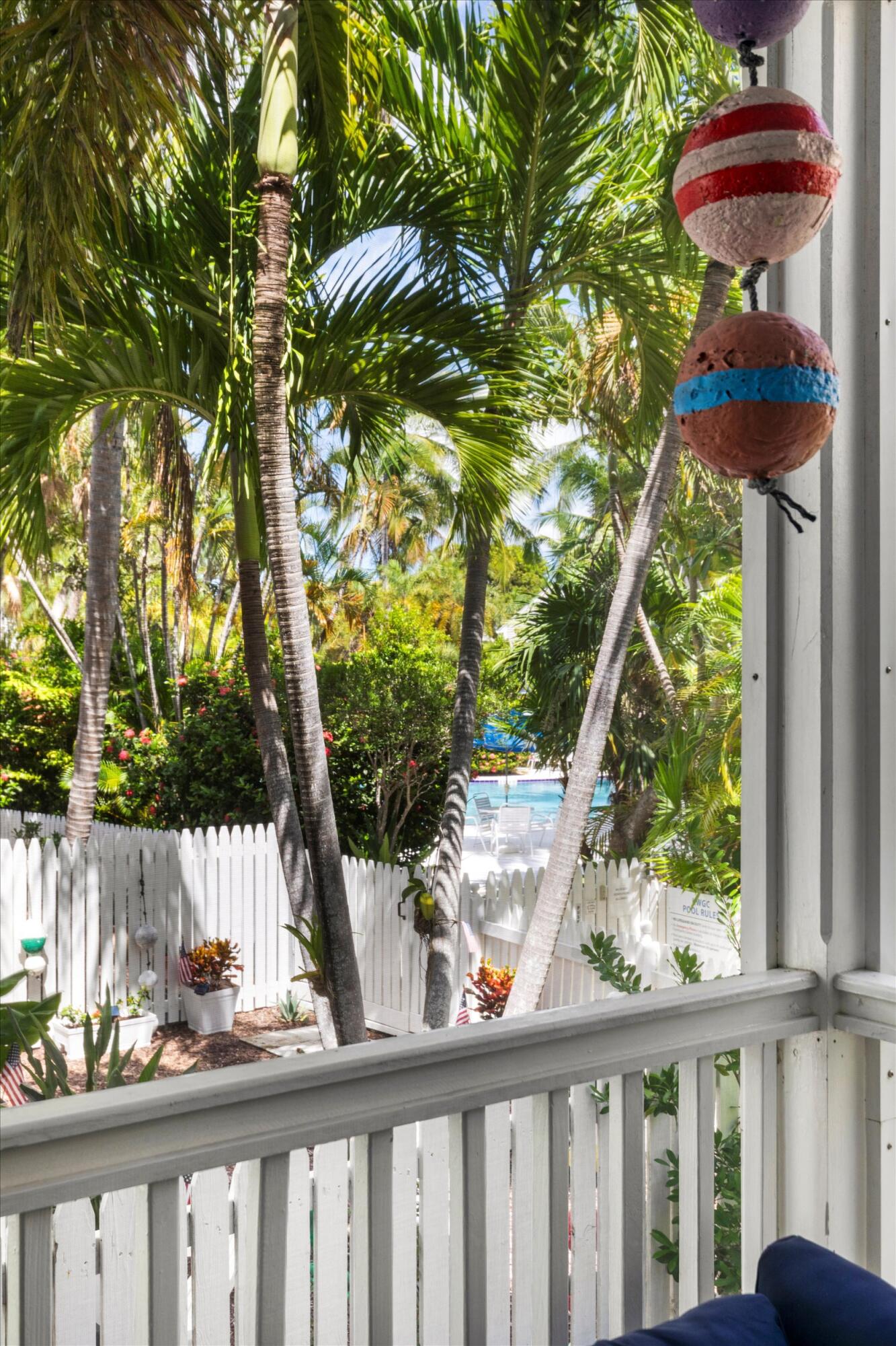 45 Spoonbill Way Key West, FL 33040 - Photo 17 of 80 a view of a porch with furniture and wooden fence