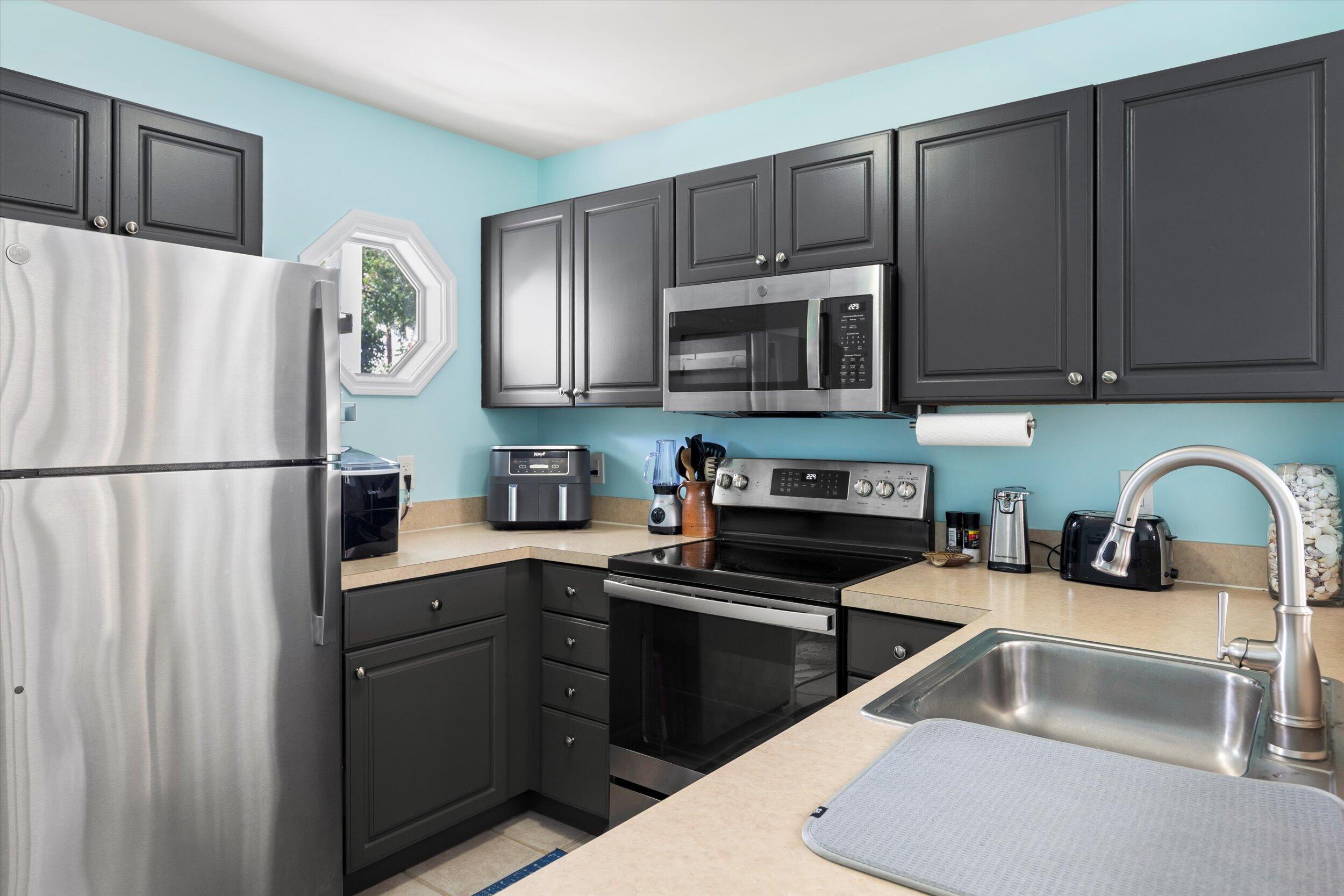 45 Spoonbill Way Key West, FL 33040 - Photo 24 of 80 a kitchen with stainless steel appliances a refrigerator a sink a stove a microwave and cabinets