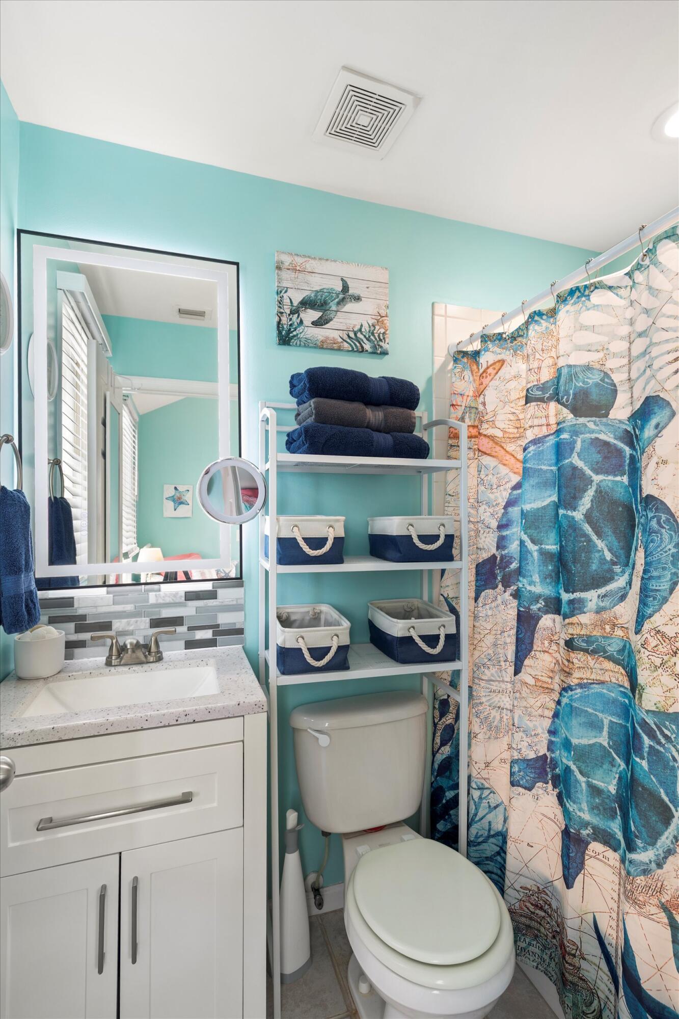 45 Spoonbill Way Key West, FL 33040 - Photo 39 of 80 a bathroom with a toilet sink and mirror