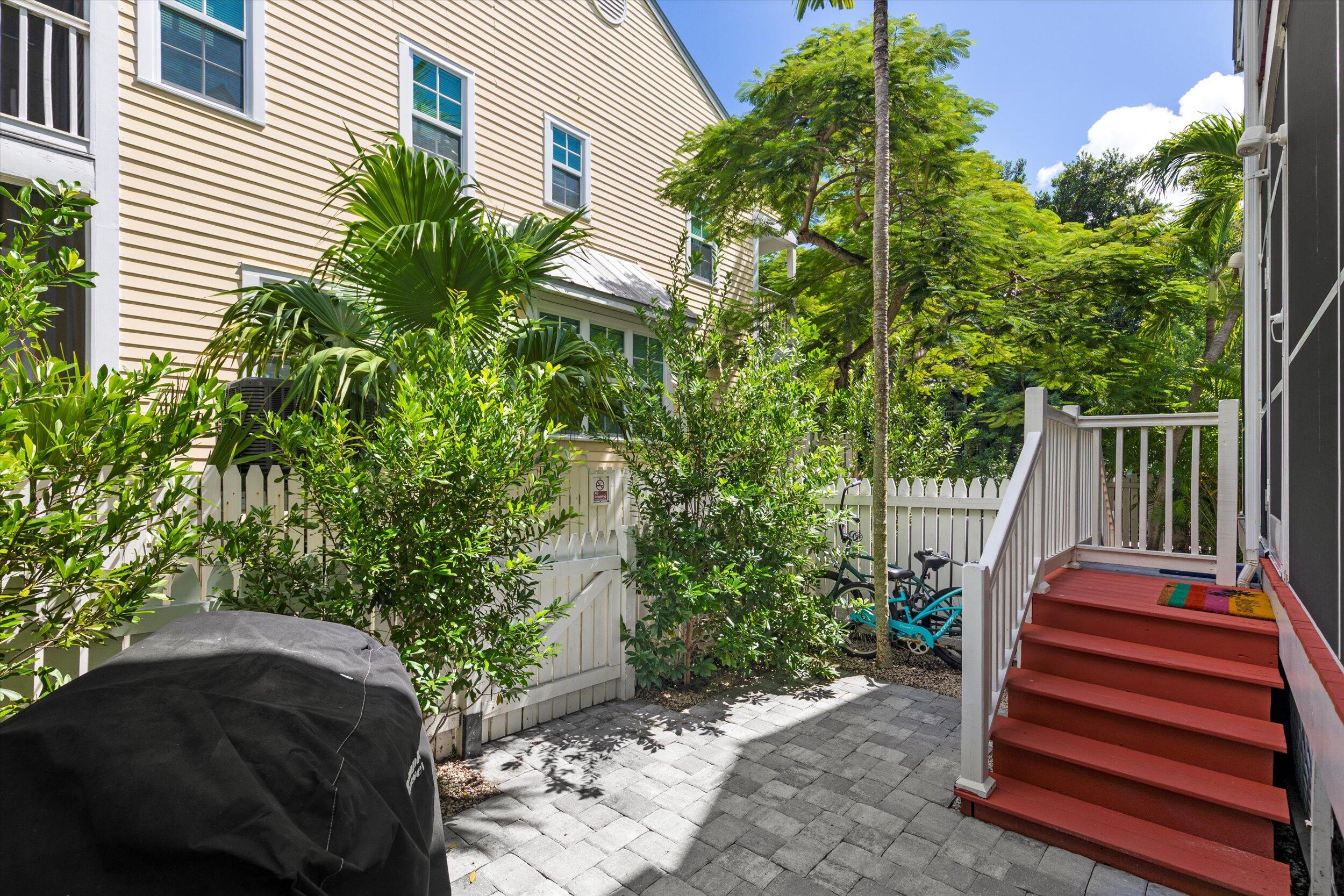 45 Spoonbill Way Key West, FL 33040 - Photo 45 of 80 a backyard of a house with large trees and plants