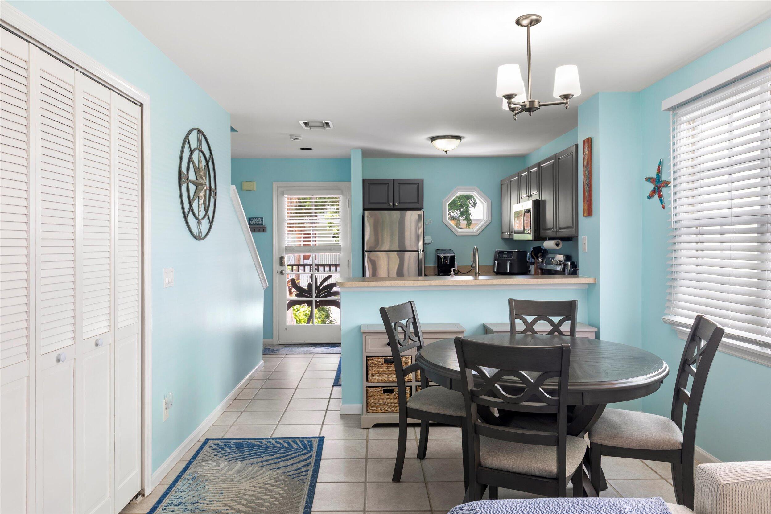 45 Spoonbill Way Key West, FL 33040 - Photo 9 of 80 a view of dining room and livingroom with furniture wooden floor a rug and a chandelier