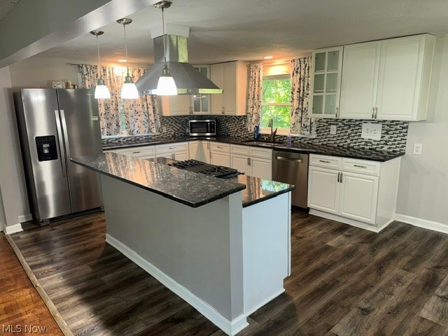 1087 Krumroy Road Akron, OH 44306 - Photo 9 of 38 Kitchen featuring a central island with cooktop, white cabinetry, dark stone countertops, and stainless steel appliances