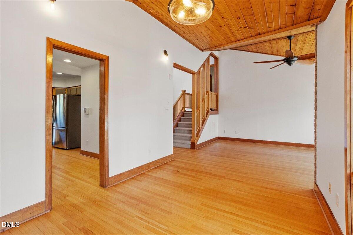 4805 Rembert Drive Raleigh, NC 27612 - Photo 11 of 45 a view of a room with wooden floor and stairs