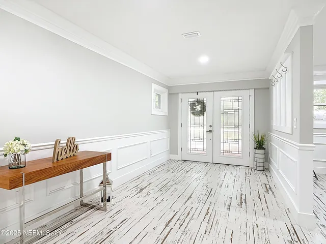 a view of a livingroom with wooden floor and a ceiling fan
