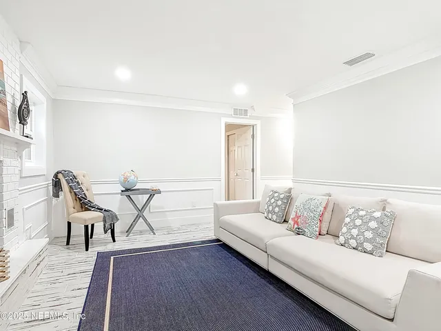 wooden floor in an empty room with a chandelier fan