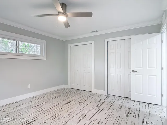 a view of room with window and wooden floor