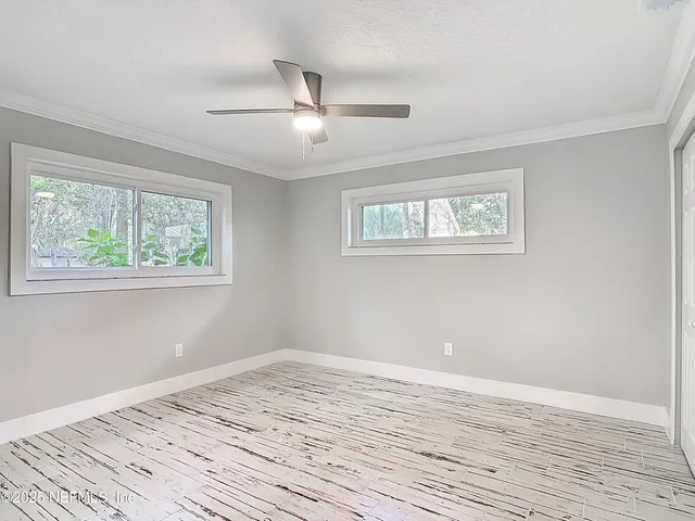 a view of a room with wooden floor