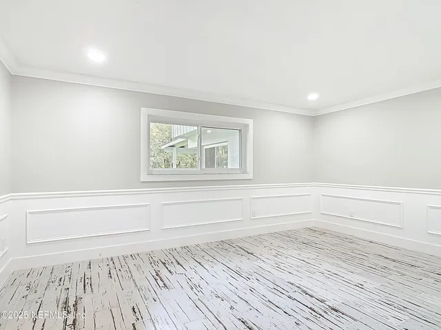 a front view of a house with a garden and swimming pool