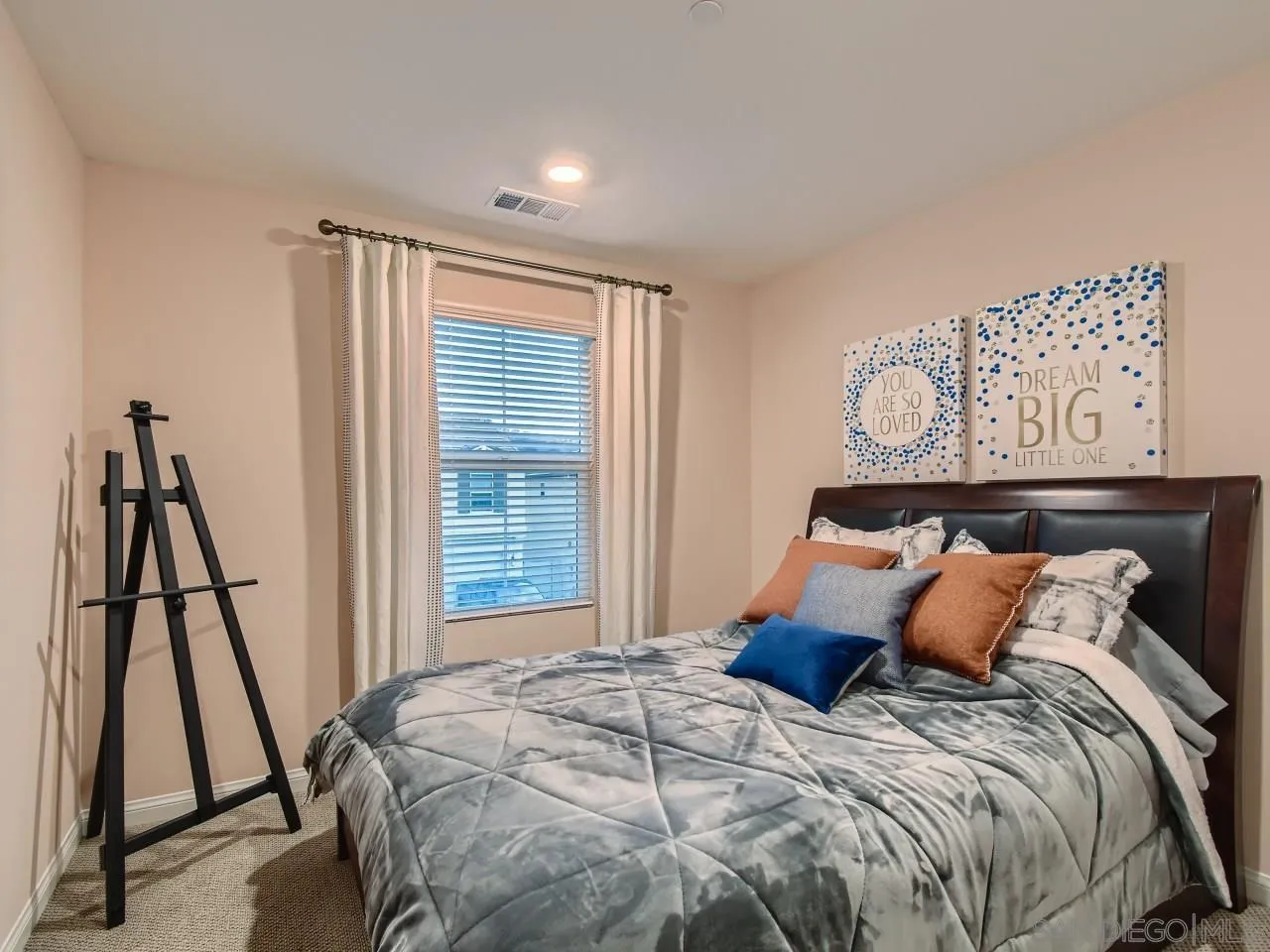 10660 Busch Street Spring Valley, CA 91978 - Photo 19 of 29 a bed sitting in a bedroom next to a window